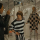 Rory Culkin stars as Joel Schumacher wearing a white and black striped top and pants in Hlaston.